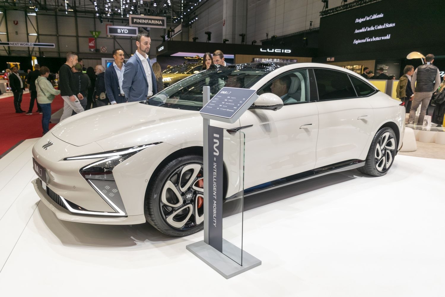 Front and side view of an electric sedan with futuristic headlights and modern wheels