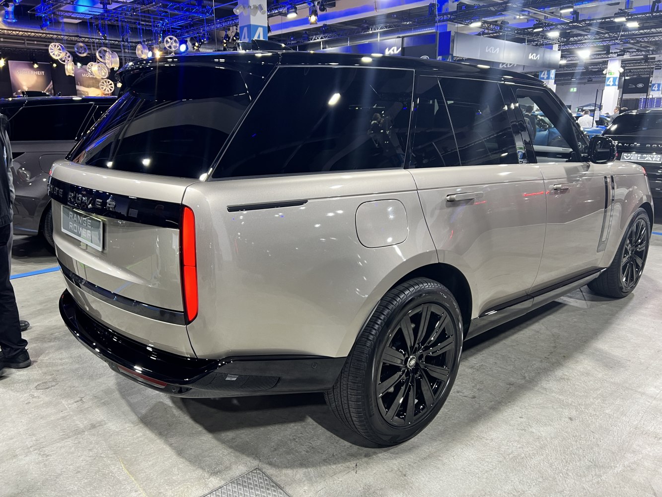 Rear and side view of a luxury SUV with black roof and wheels