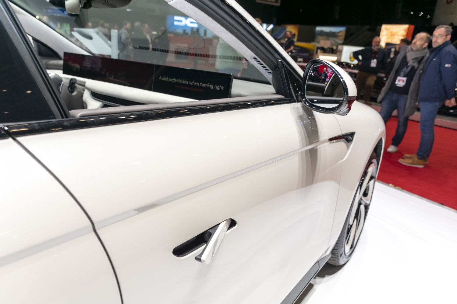 Close-up of sleek car door handle and side mirror
