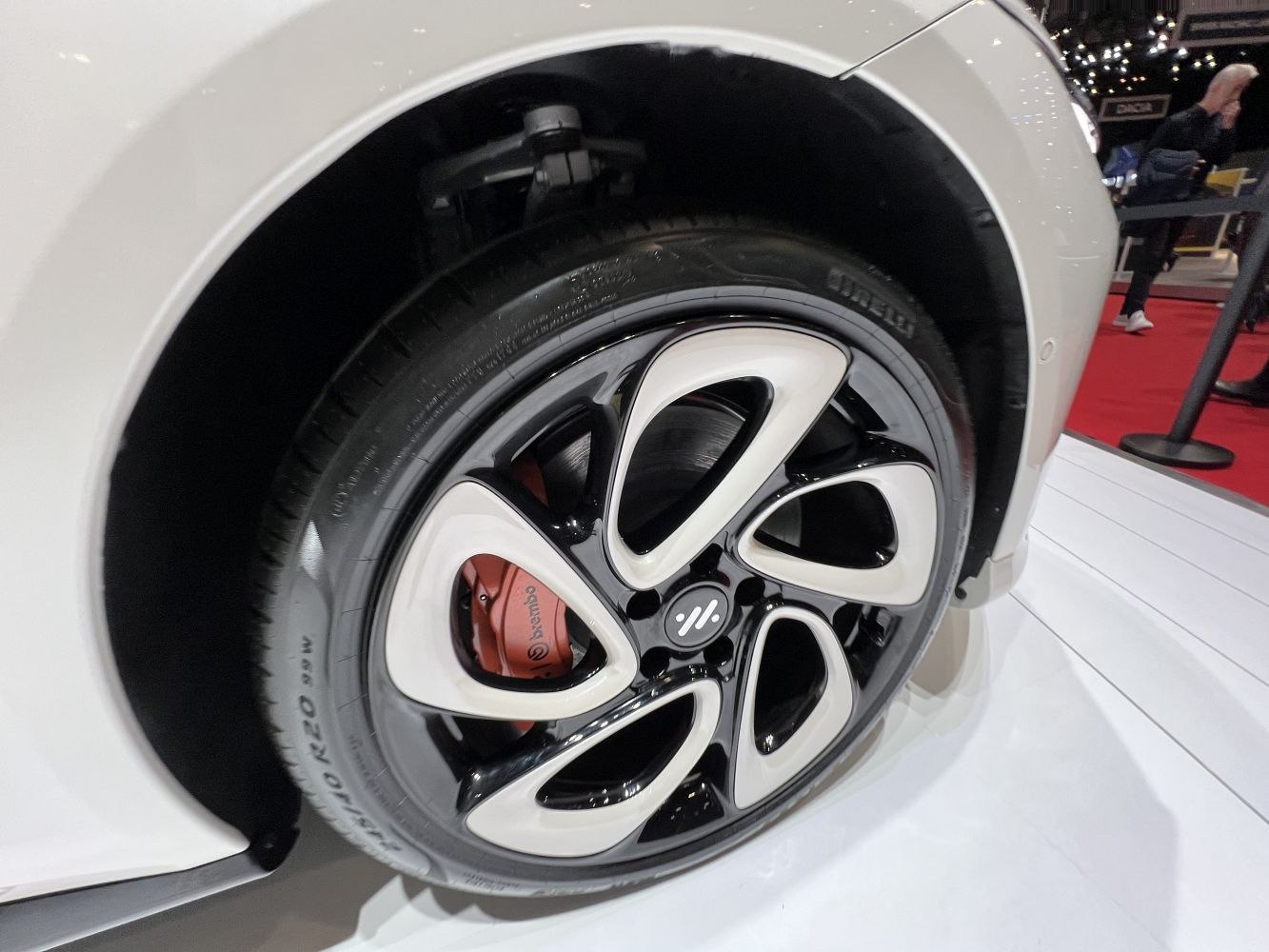 Close-up of alloy wheel with red Brembo brake caliper.