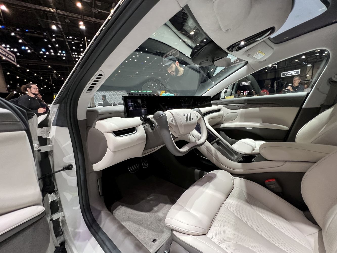 Futuristic yoke steering and digital dashboard with premium white leather interior
