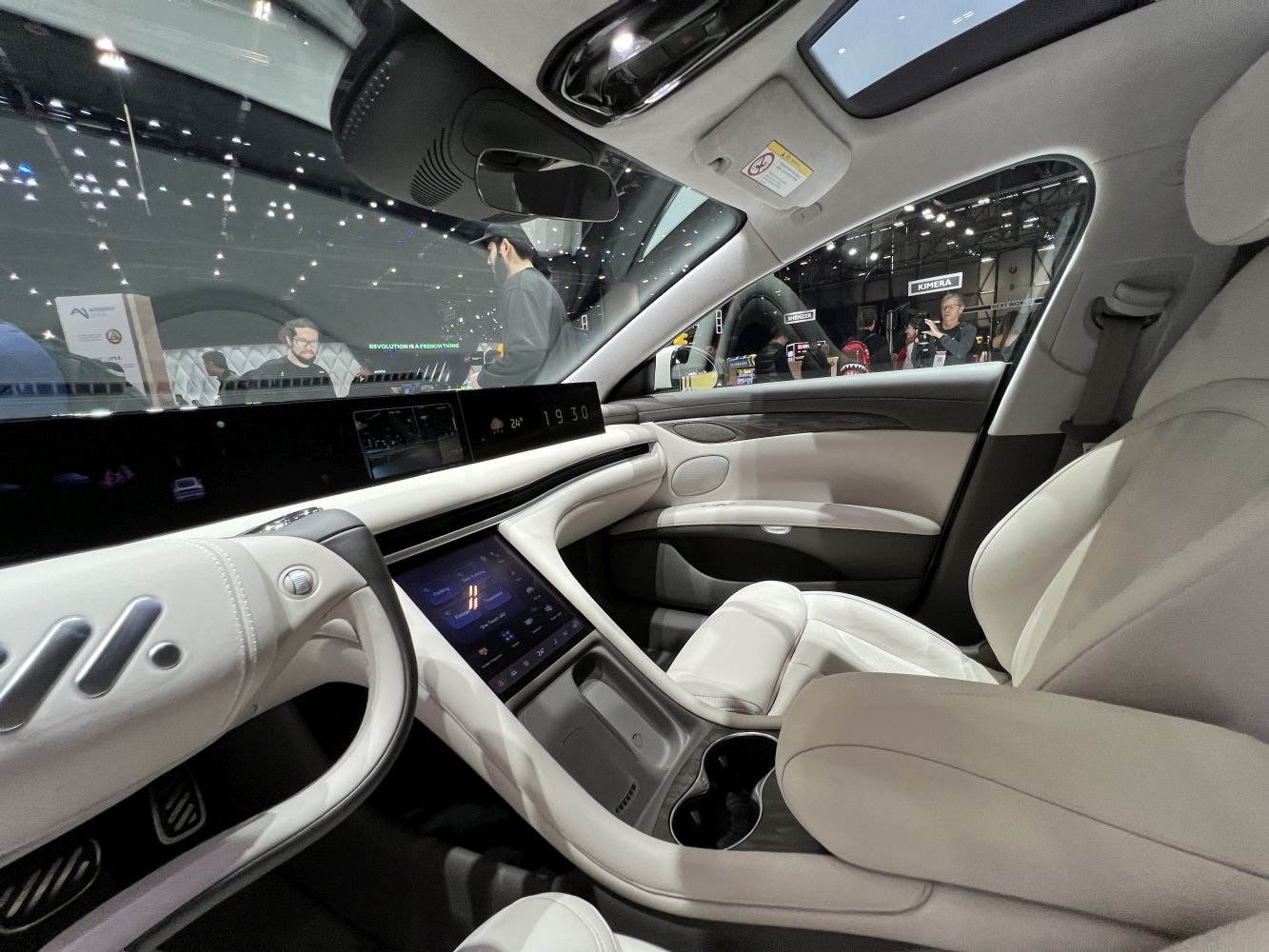 Modern digital dashboard and touchscreen center console with white leather interior