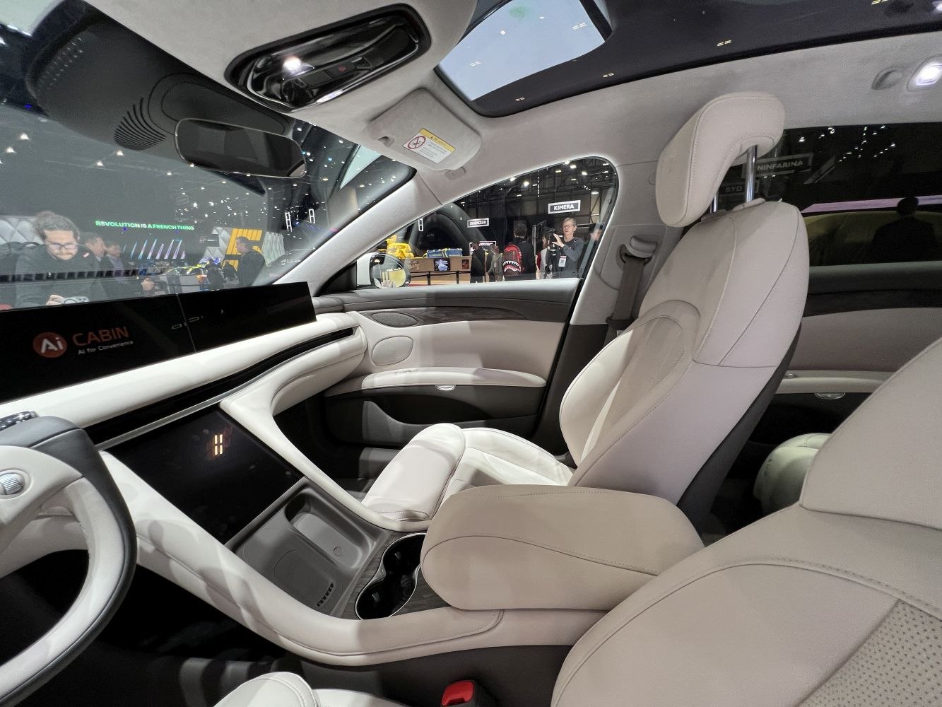Luxury beige leather seats with panoramic sunroof and AI cabin display
