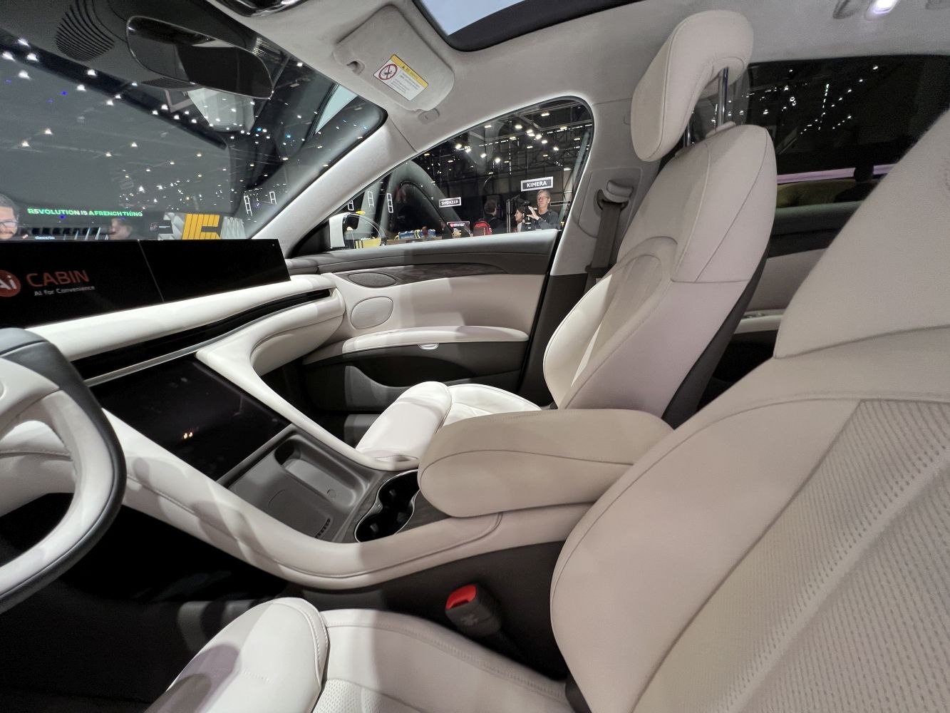 Modern car interior with digital displays and premium light upholstery seats