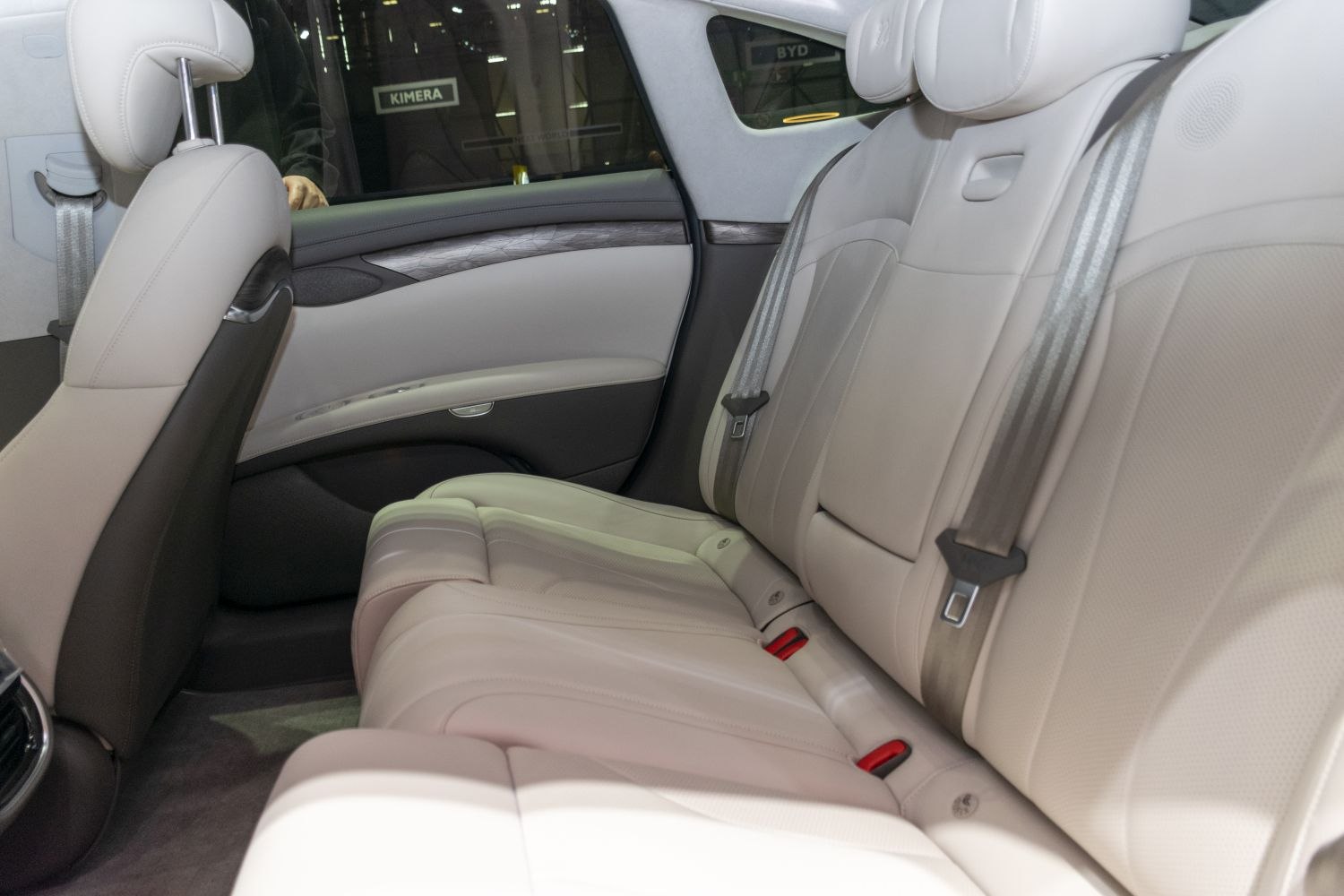 Luxurious beige leather rear seats with modern design and integrated seat belts