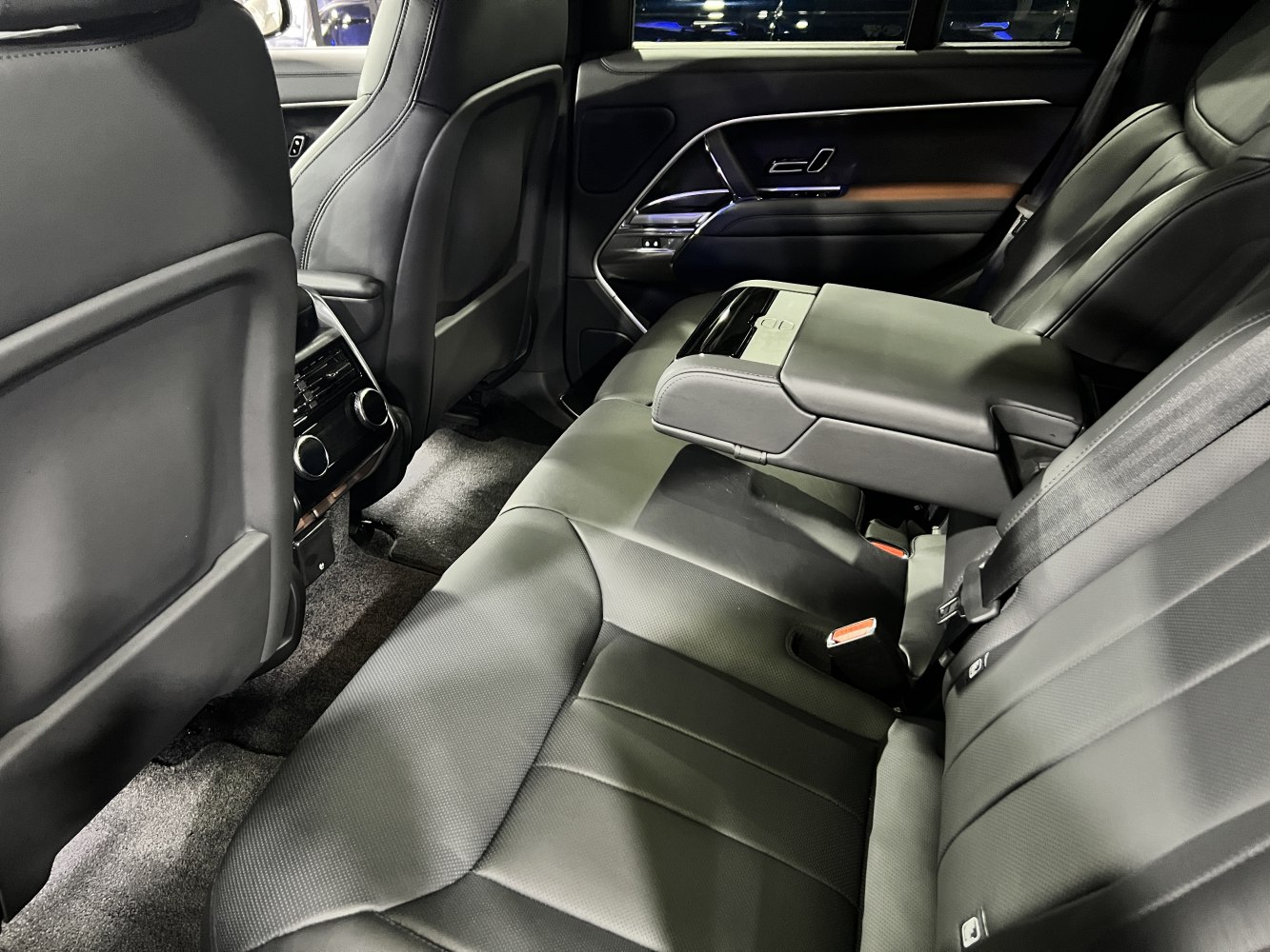 Rear seat leather interior with fold-down armrest and climate control vents