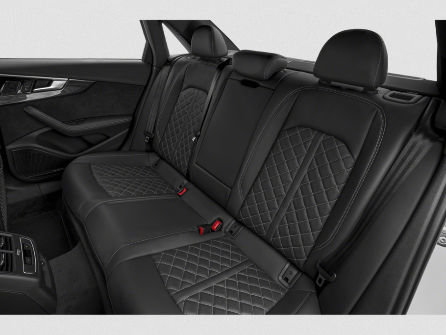 Quilted leather rear seat with stitching and headrests