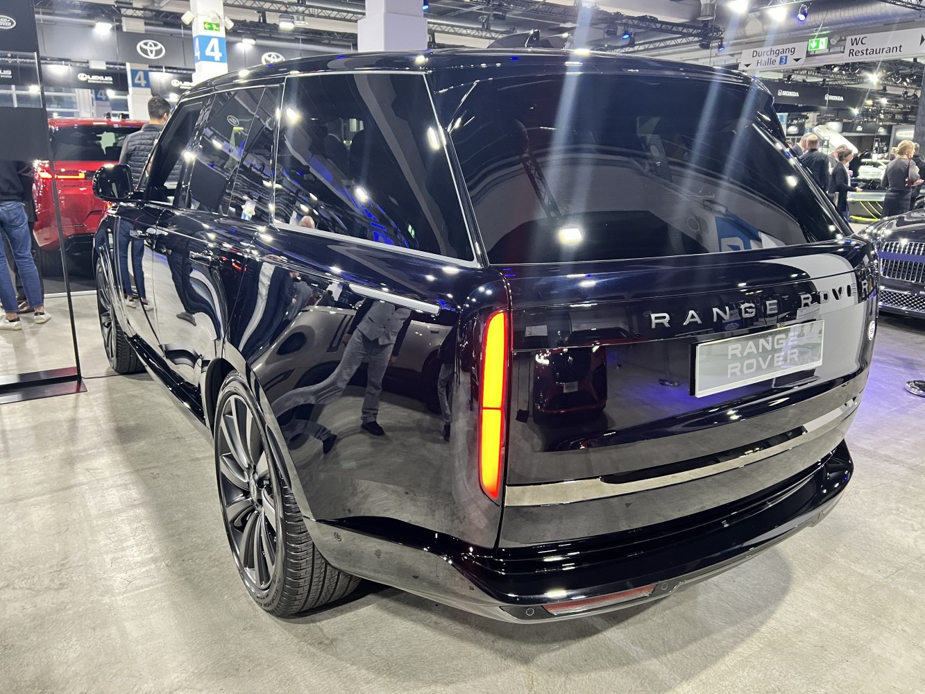 Sleek black luxury SUV rear with vertical tail lights and polished finish
