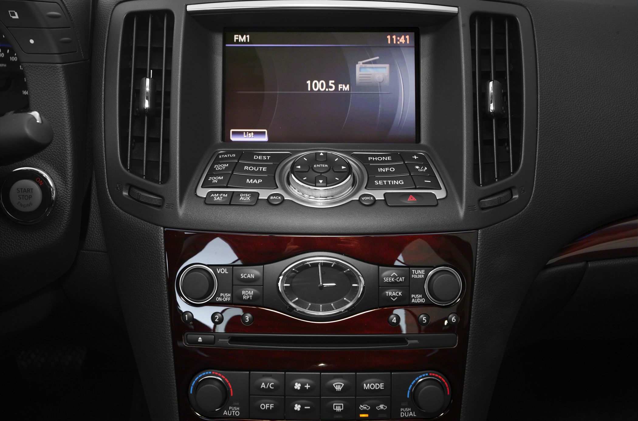 Center console with navigation screen, analog clock, and climate controls