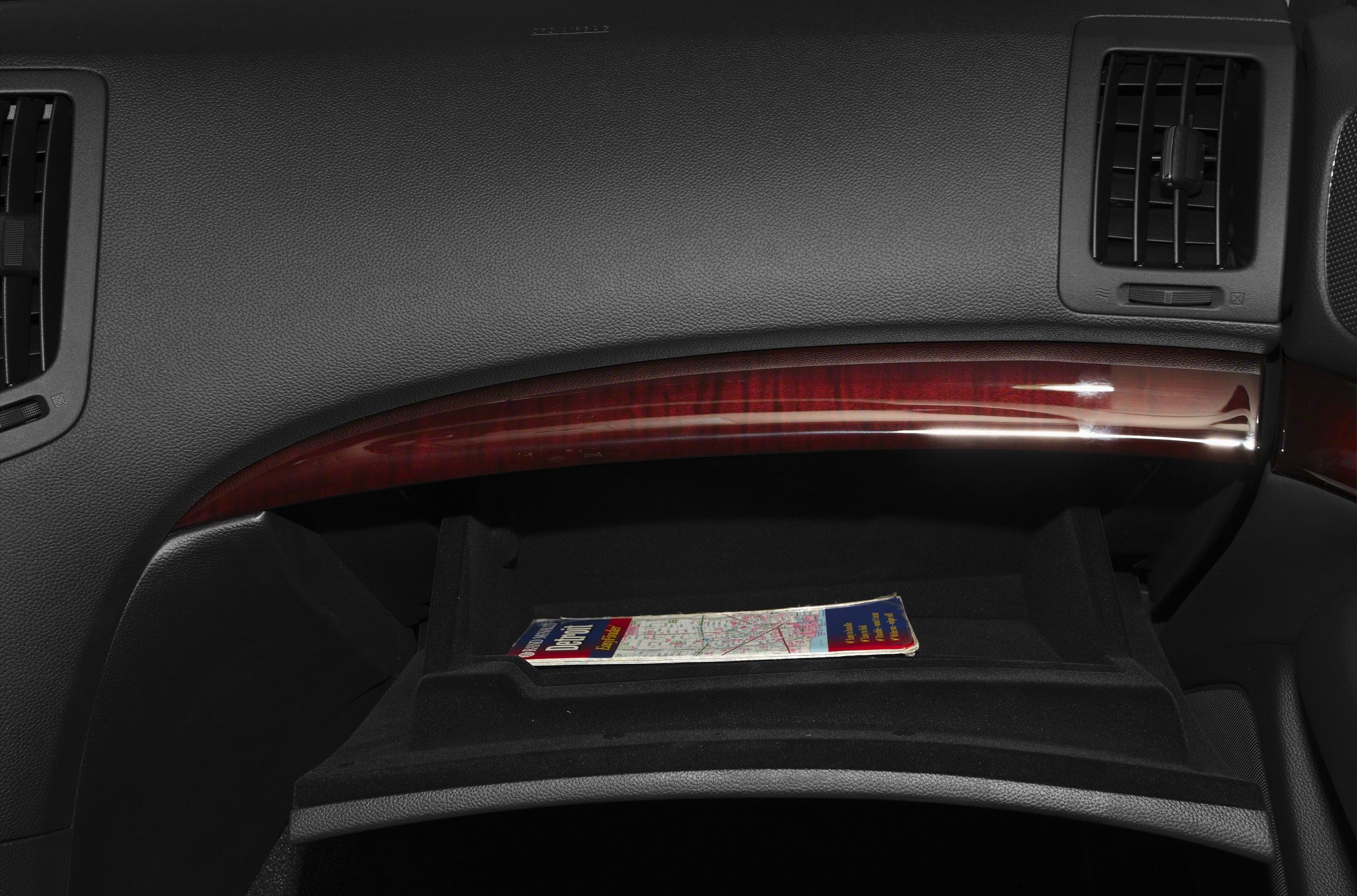 Glove compartment with polished wood trim and air vents