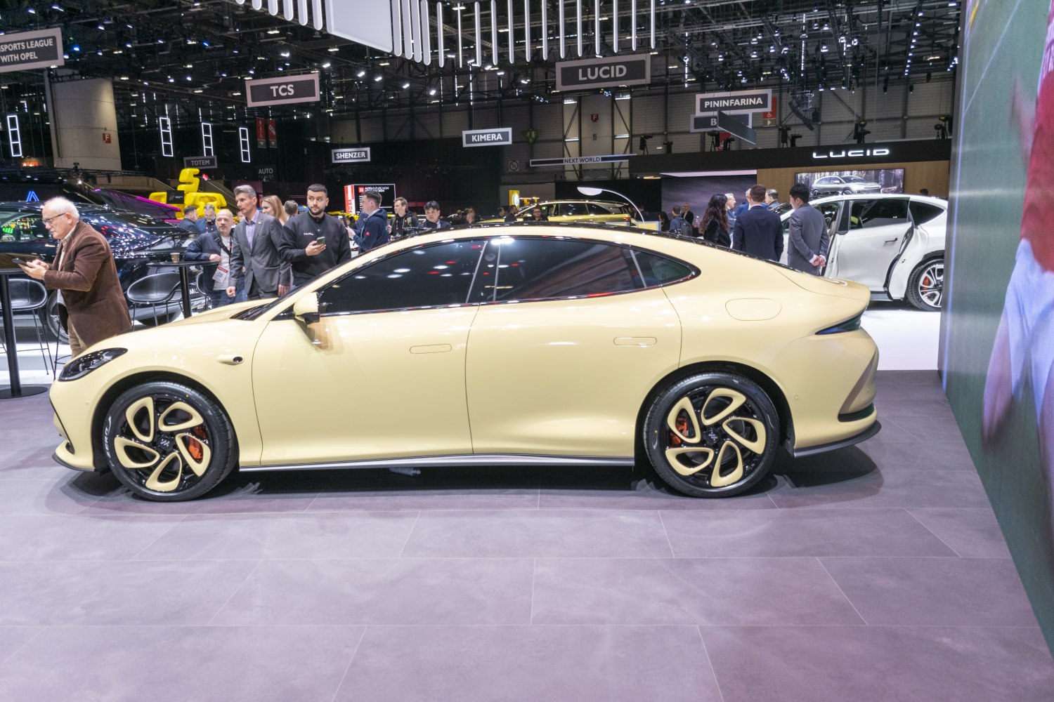 Sleek electric sedan side profile with distinct four-spoke wheels