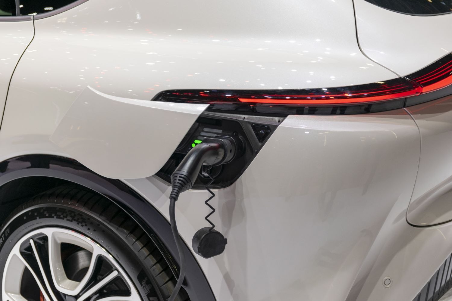 Electric vehicle charging port and rear LED taillight near rear wheel