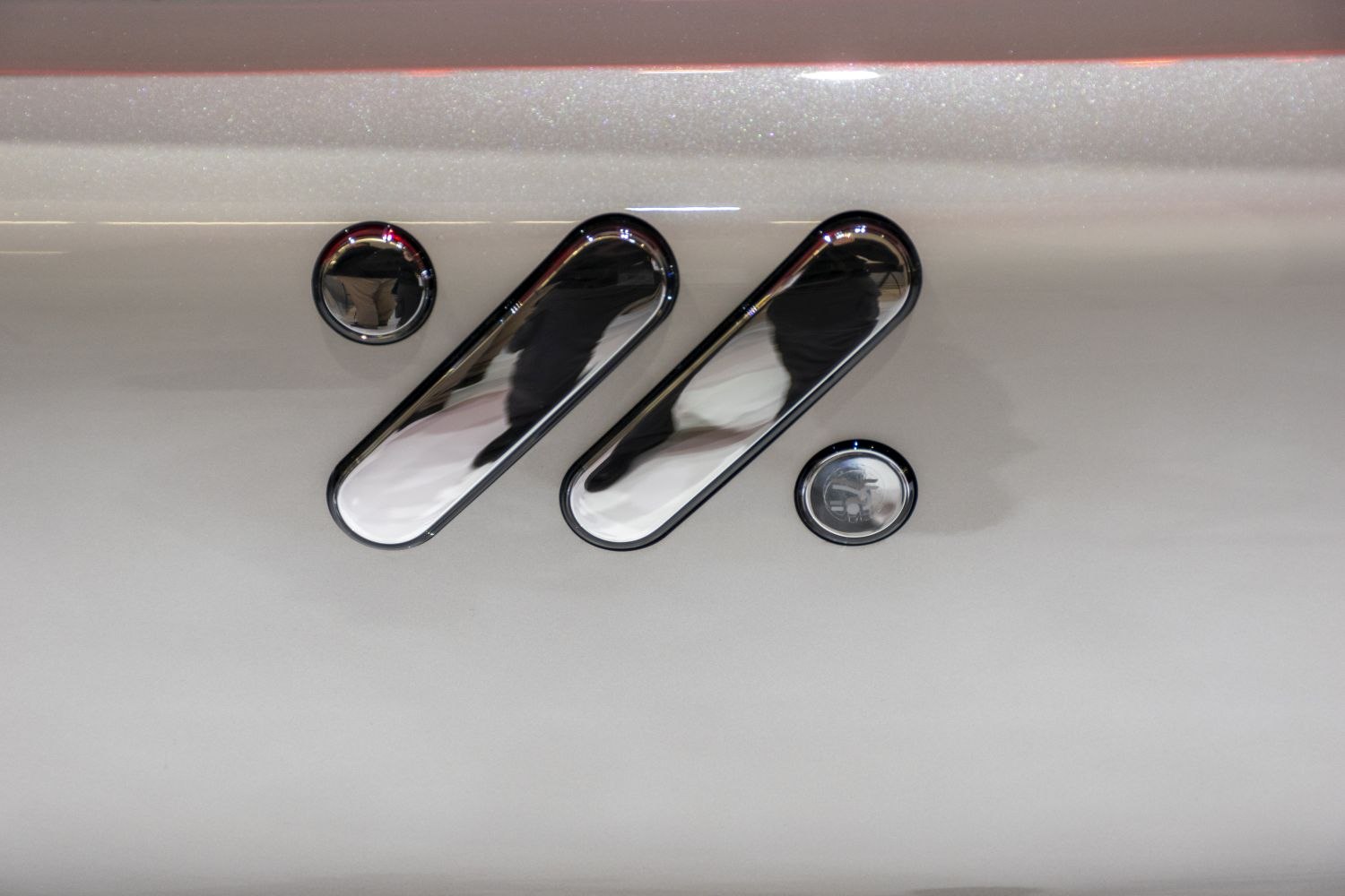 Chrome side vents and round accents on smooth vehicle body surface