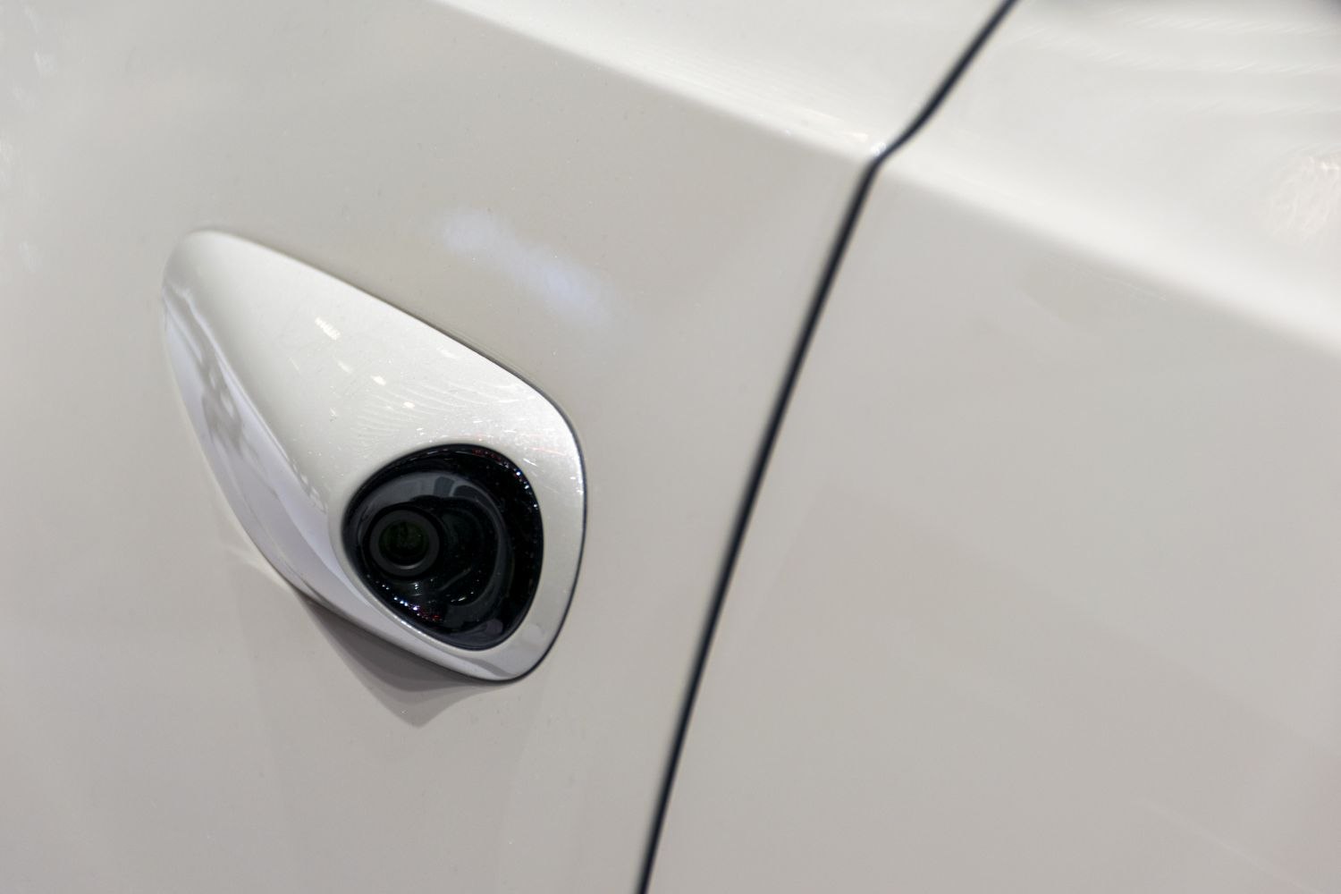 Close-up of a side mirror camera integrated in vehicle door