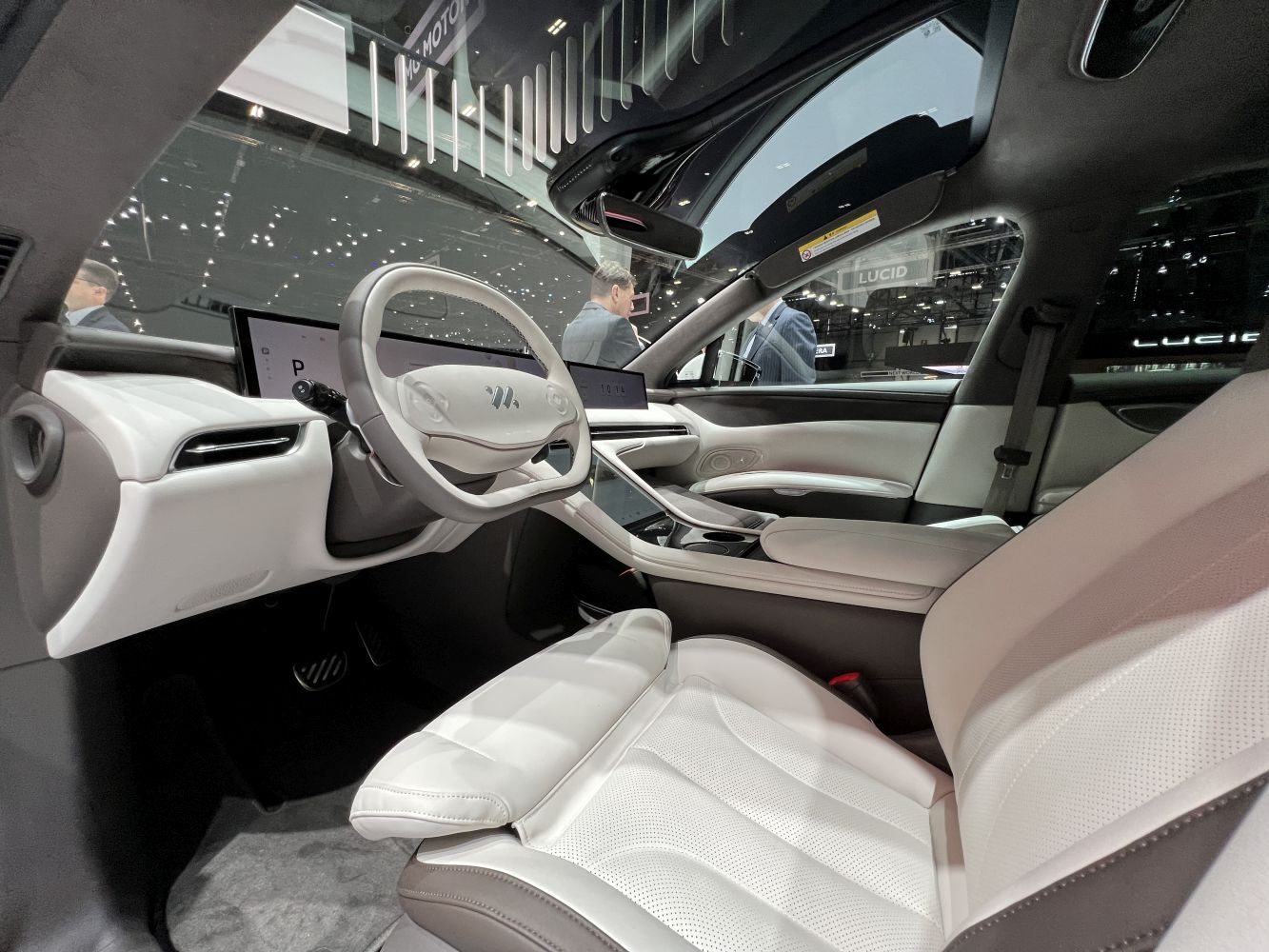 Futuristic steering wheel and widescreen digital displays in modern vehicle interior