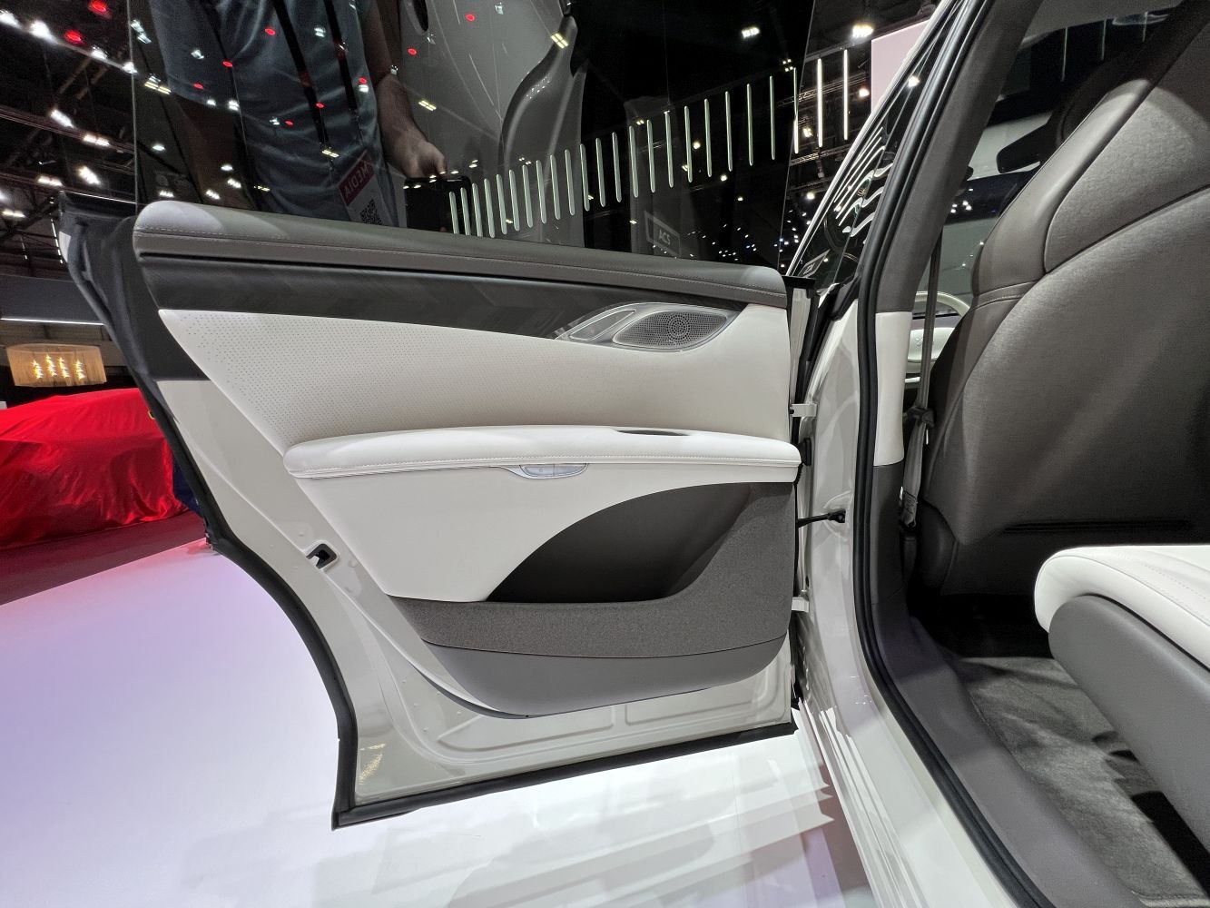 Rear door interior panel with leather, trim, and armrest design