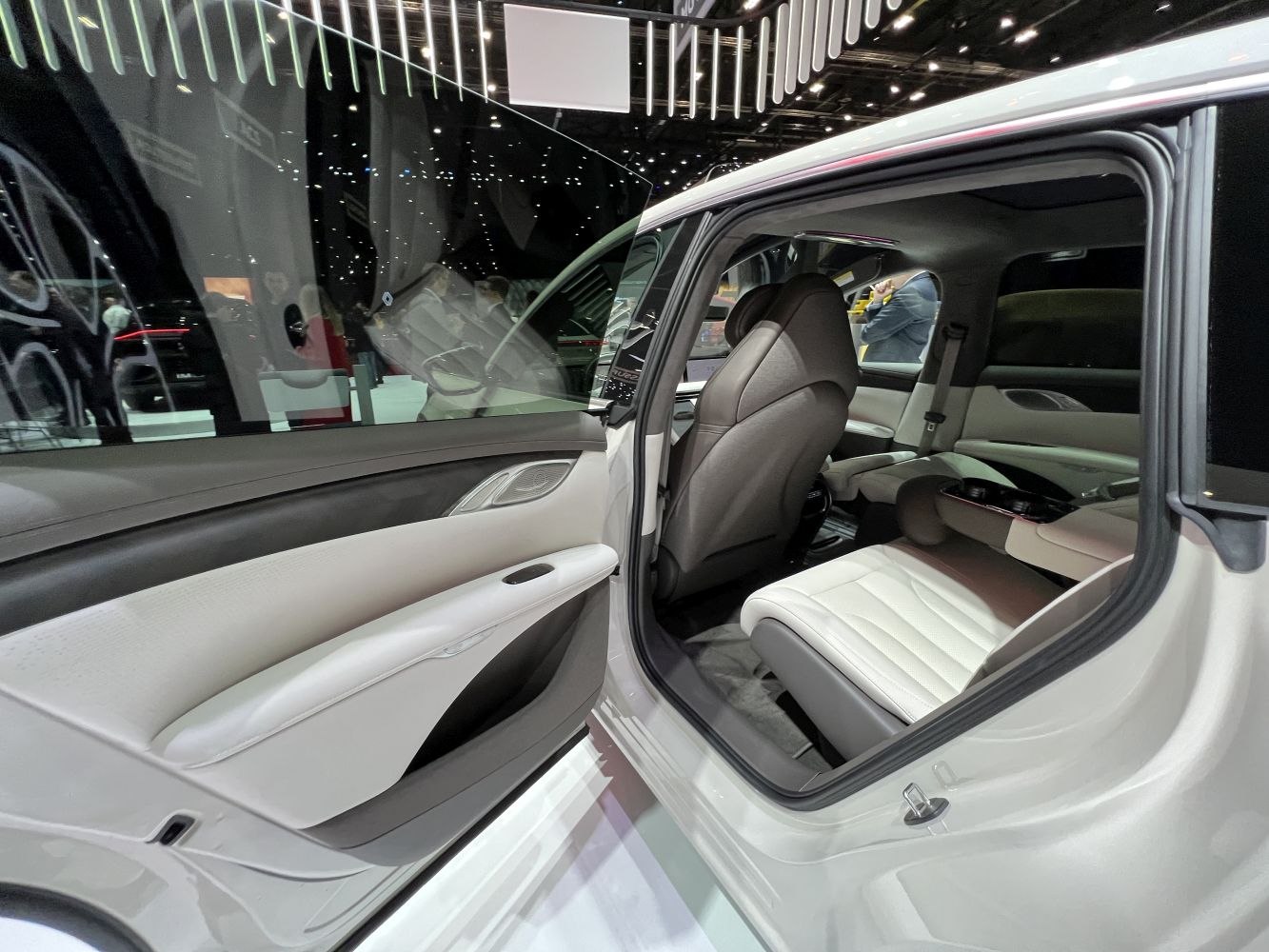 Luxury rear passenger seat and door panel interior in white and black tones