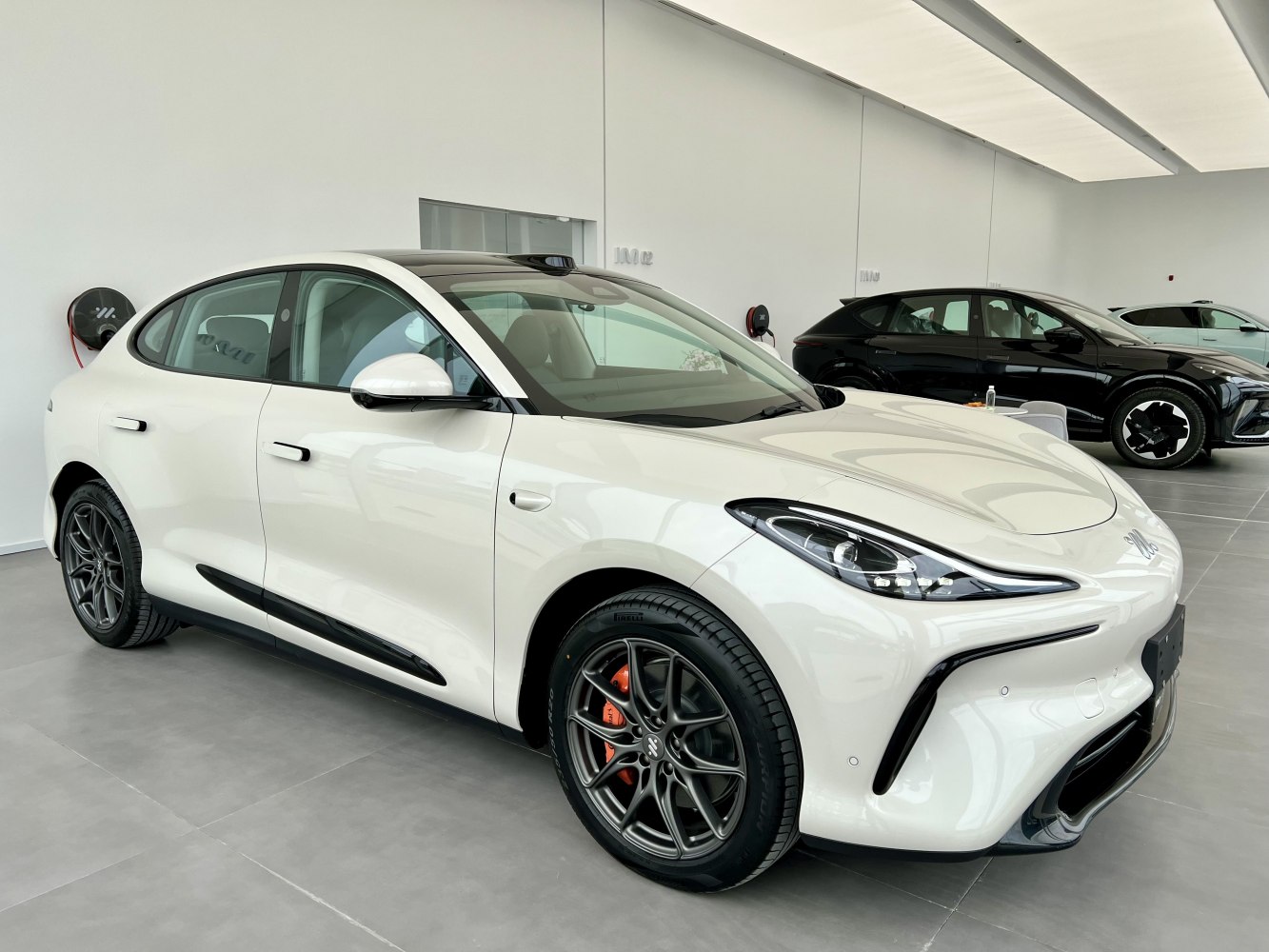 Sleek white electric crossover with aerodynamic front and alloy wheels