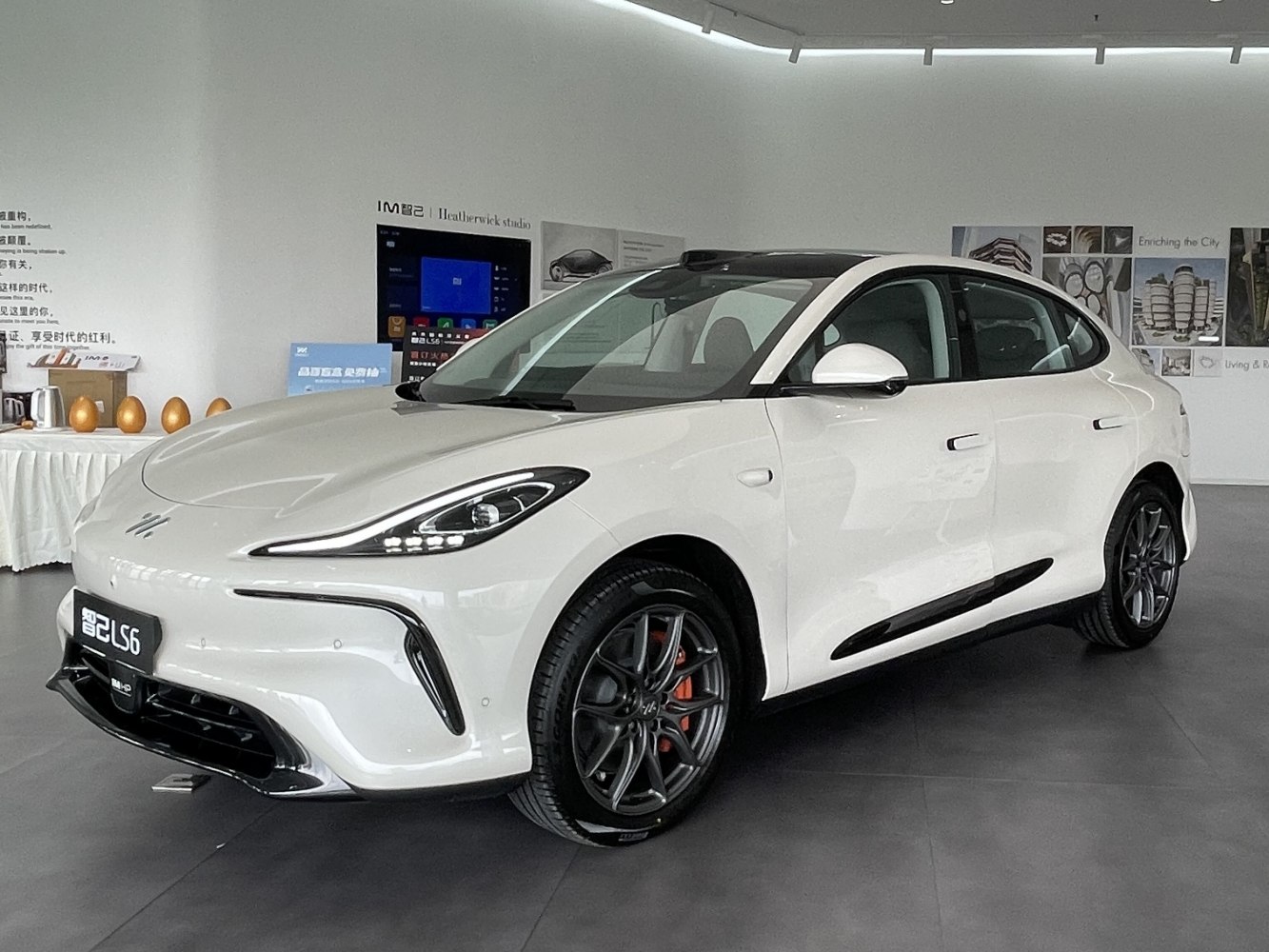 Aerodynamic front design with sporty alloy wheels on a white electric crossover