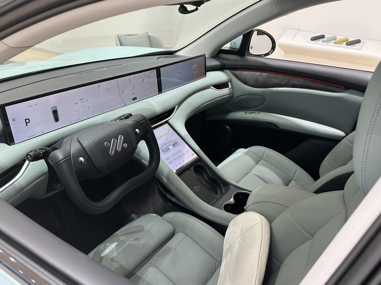 Dual expansive touchscreen dashboard and unique rectangular steering wheel