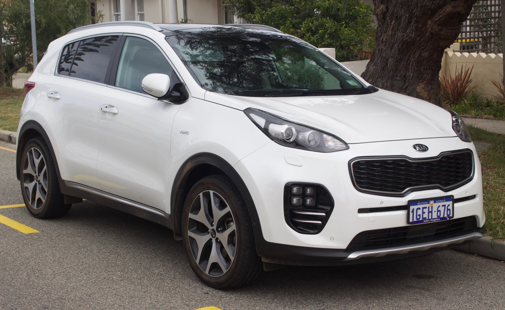 White SUV with distinctive grille and quad fog lights front view
