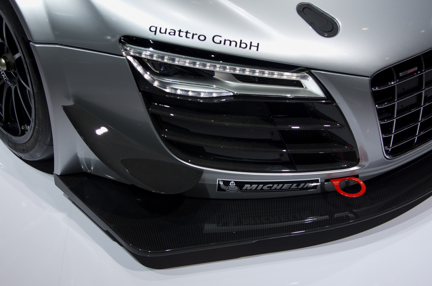 Close-up of front bumper, LED headlight, carbon fiber splitter
