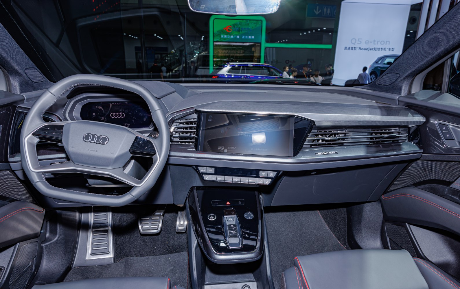 Digital dashboard, modern steering wheel, and center console with gear selector
