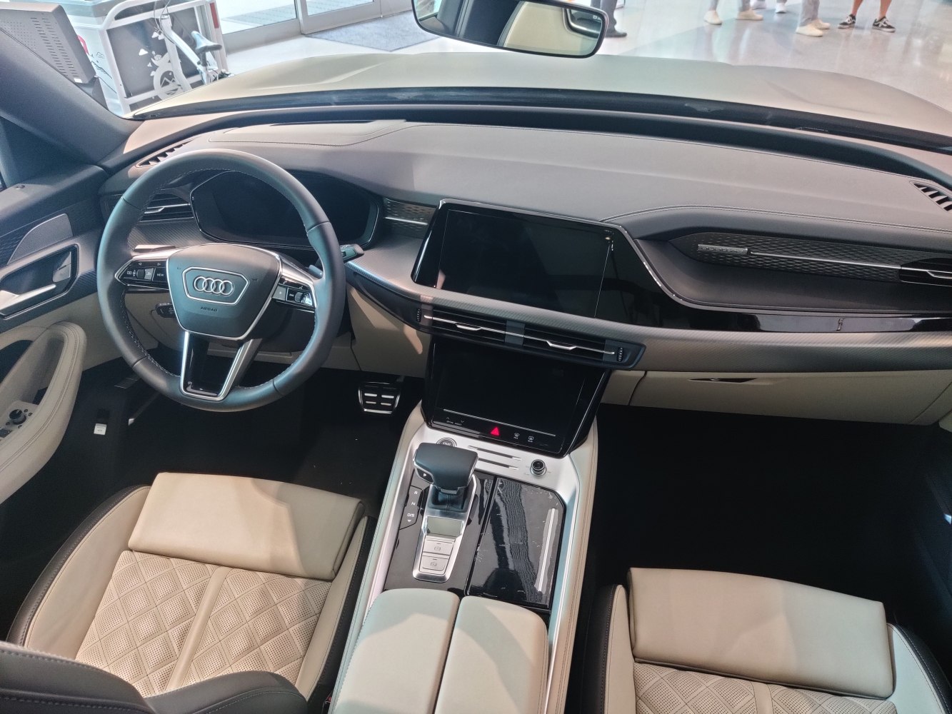 Modern dashboard with dual digital displays and premium quilted leather seats