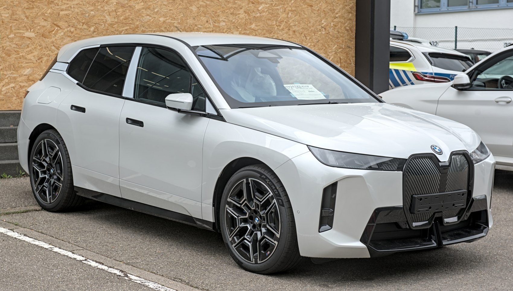Front and side view with large grille, sleek headlights, unique wheels