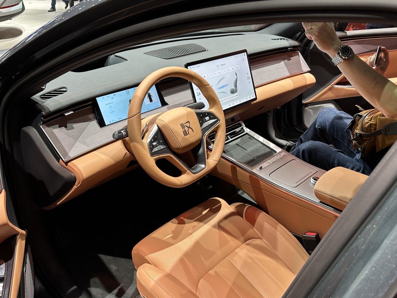 Luxury tan leather interior with dual digital displays and multifunction steering wheel