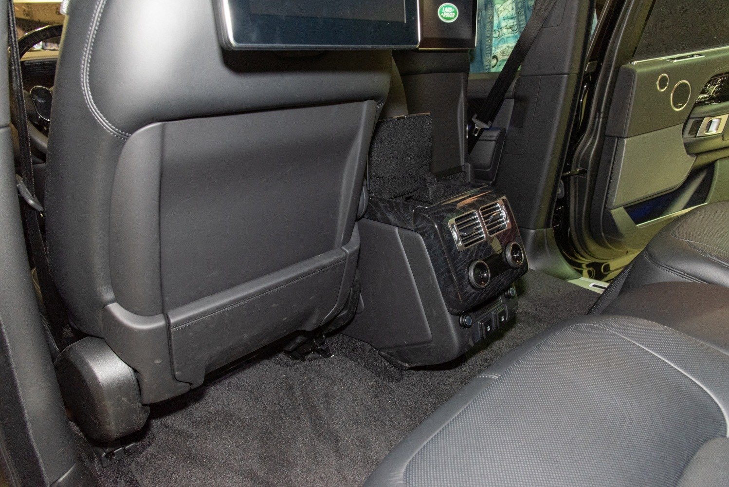 Rear seat climate control vents and storage console in luxury SUV interior