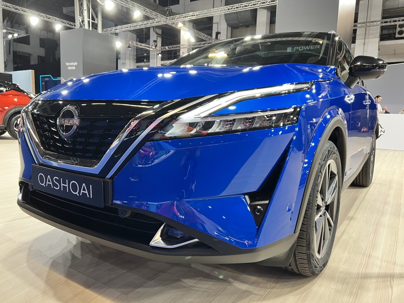 Close-up of front grille and sleek LED headlights on blue vehicle