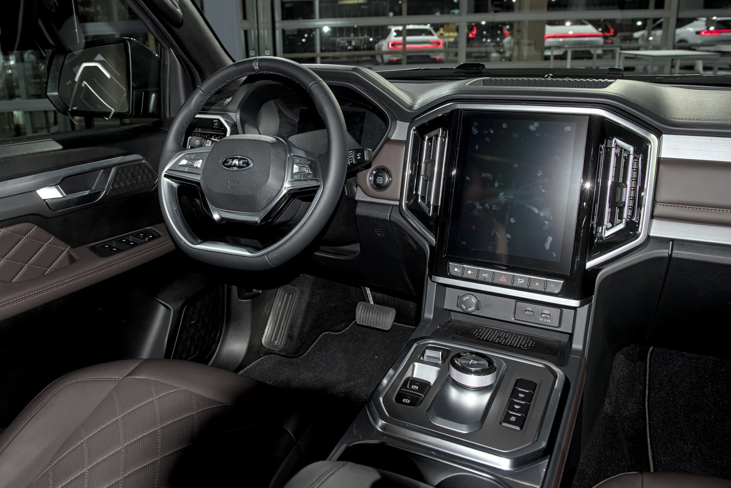 Modern steering wheel and large touchscreen with center console controls