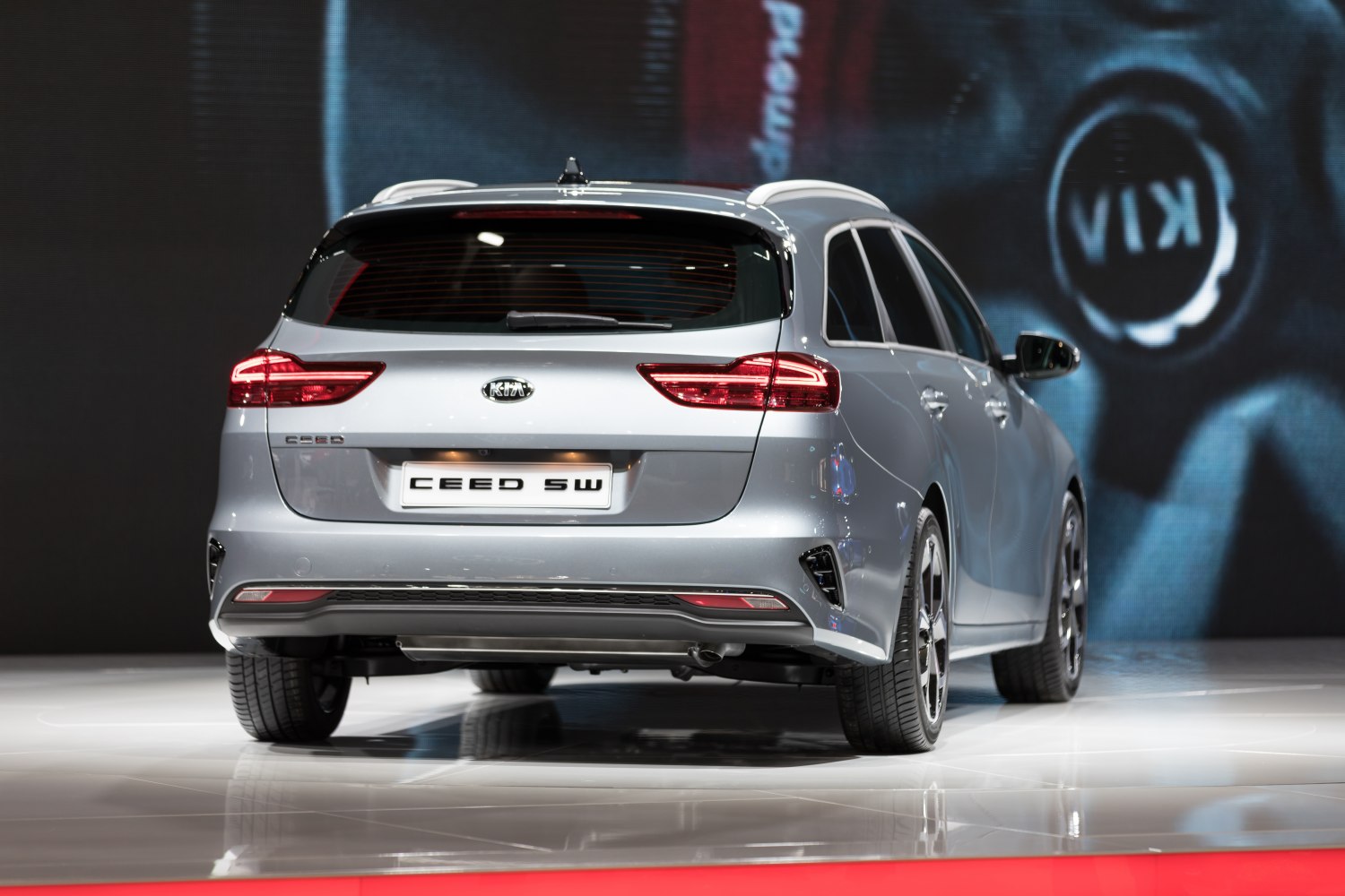 Rear view of a silver station wagon with modern taillights and alloy wheels