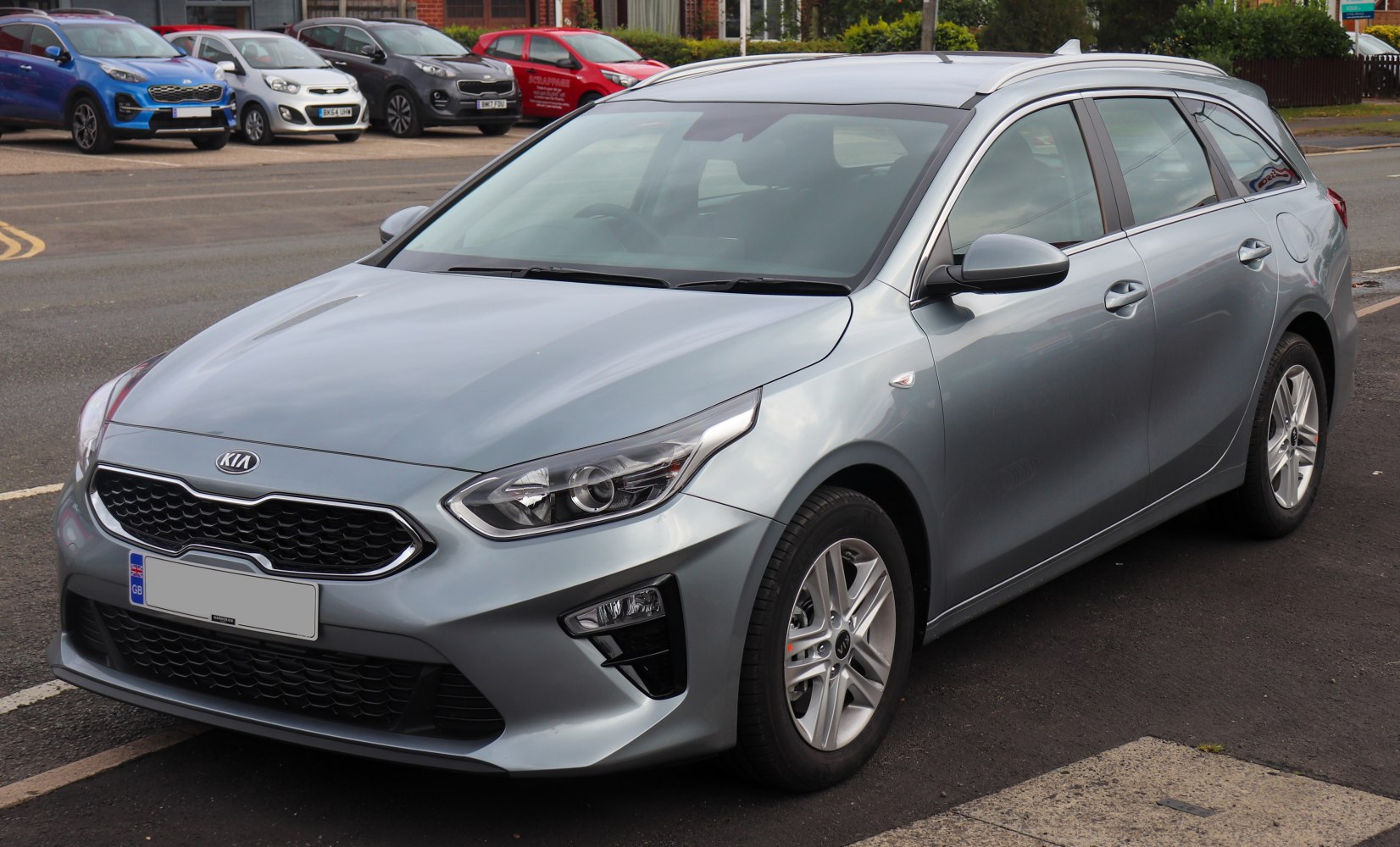 Front side view of a modern estate with alloy wheels and sleek headlights