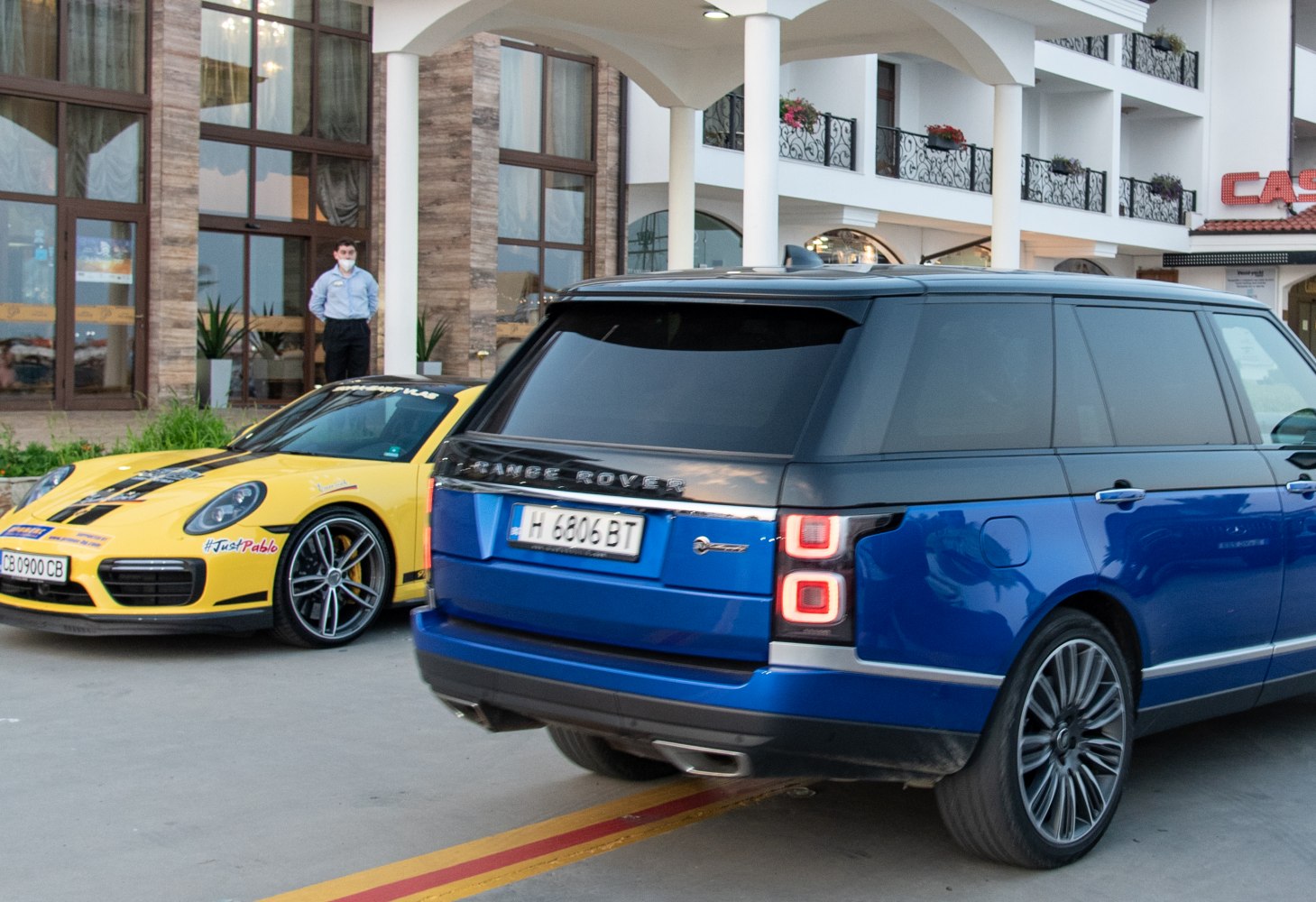 Rear view of a blue SUV with distinctive LED tail lights and dual exhausts