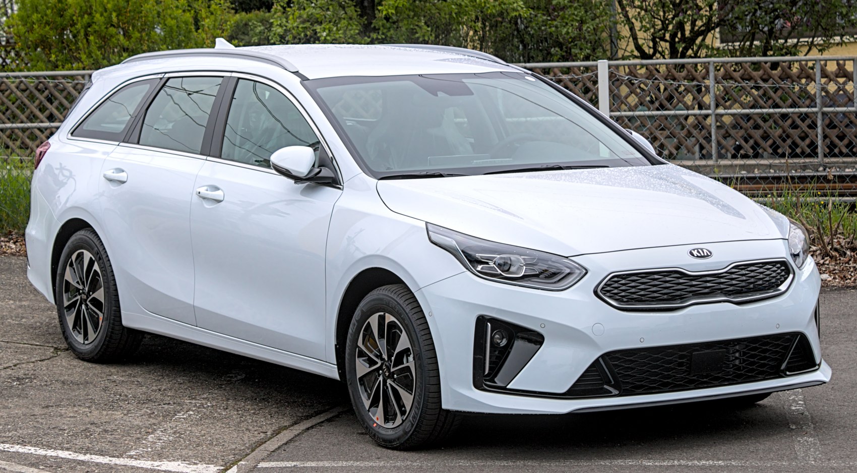 Front and side view of white sporty station wagon with modern design