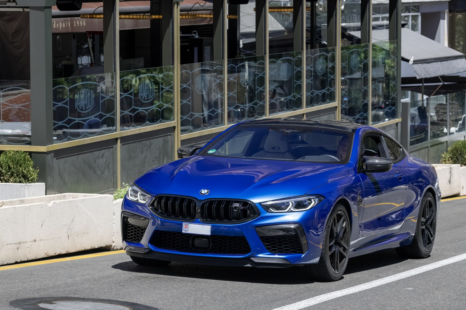 Blue luxury coupe with black kidney grille and sporty front design