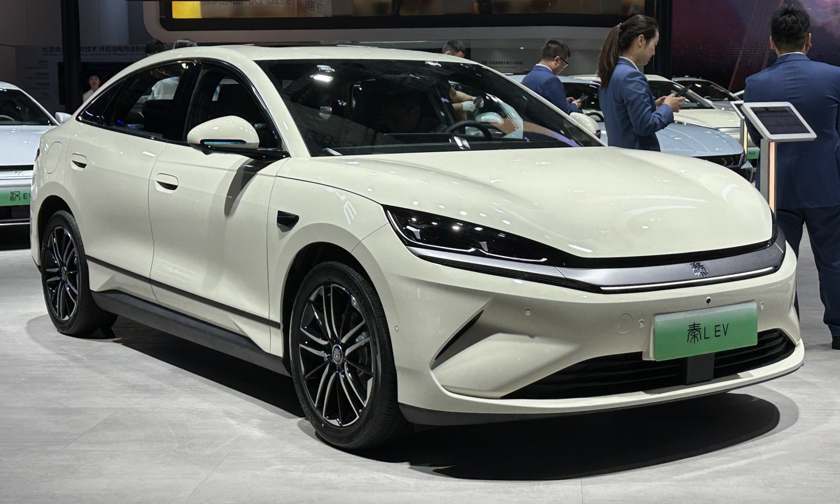 Sleek electric sedan with LED headlights and aerodynamic front design.