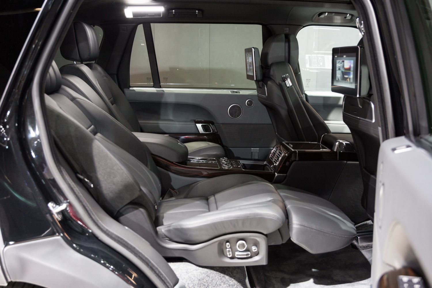 Spacious rear interior with reclining leather seats and entertainment screens