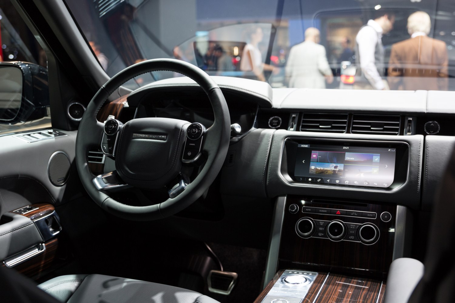 Luxury SUV interior with steering wheel and touchscreen dashboard