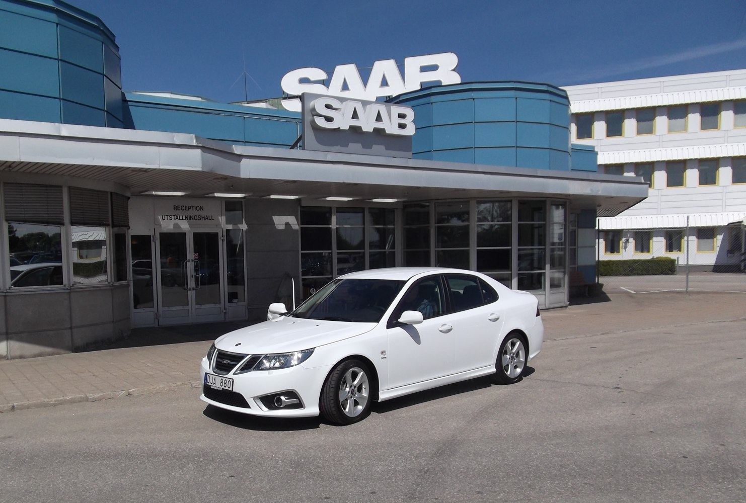 White sedan with sporty front grille and alloy wheels