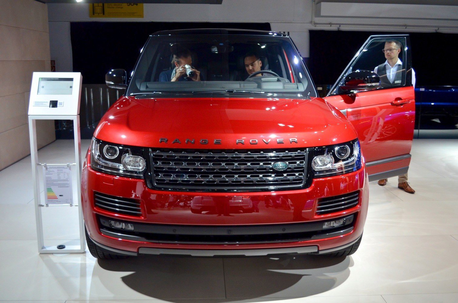 Front view of red SUV with LED headlights and distinctive grille
