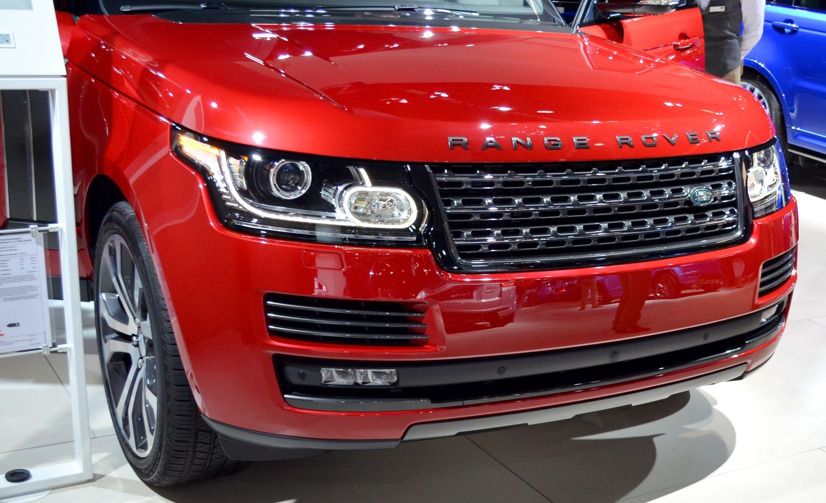 Close-up of front grille and LED headlights on red luxury SUV