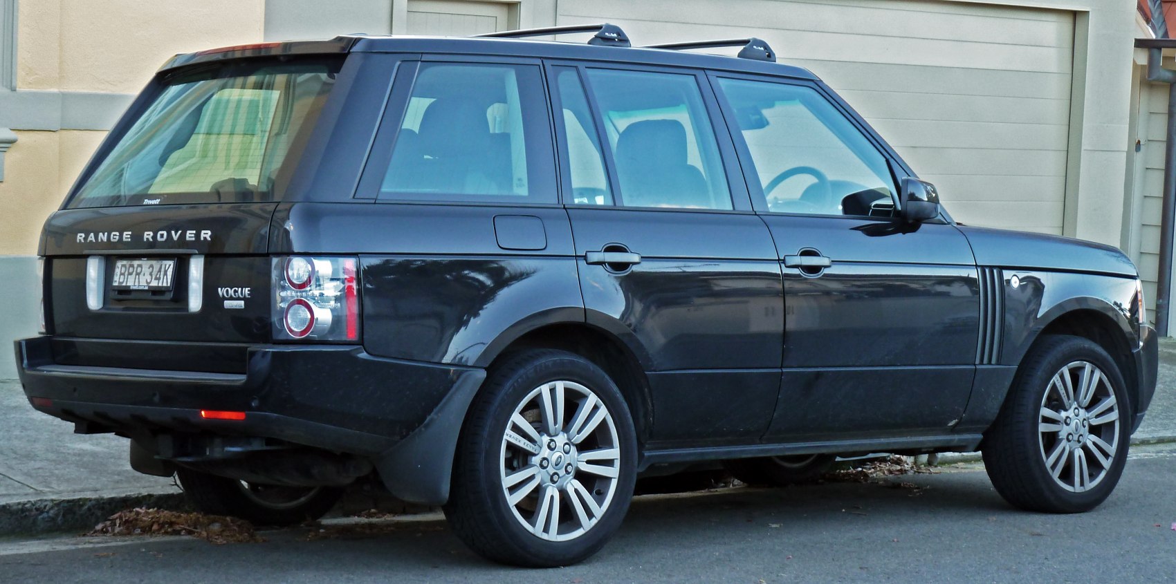 Rear side view showing tail lights and alloy wheels of large SUV