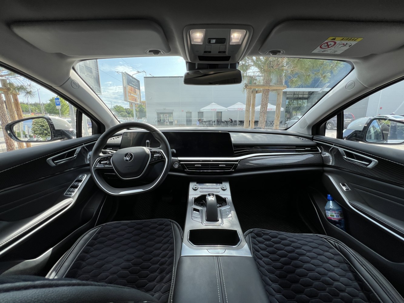 Modern car interior with digital dashboard, steering wheel, and center console