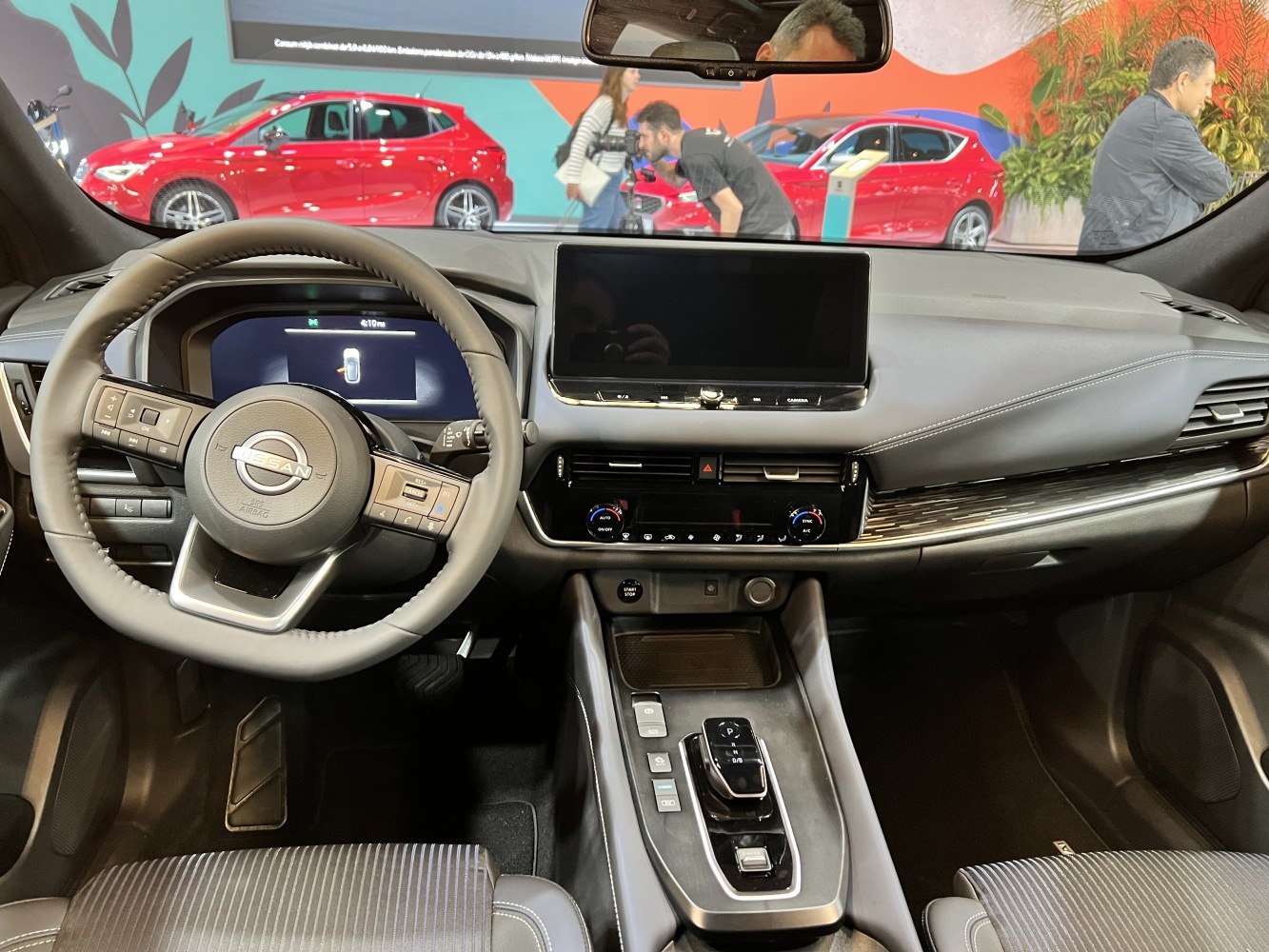 Modern car interior with digital dashboard and touchscreen infotainment.