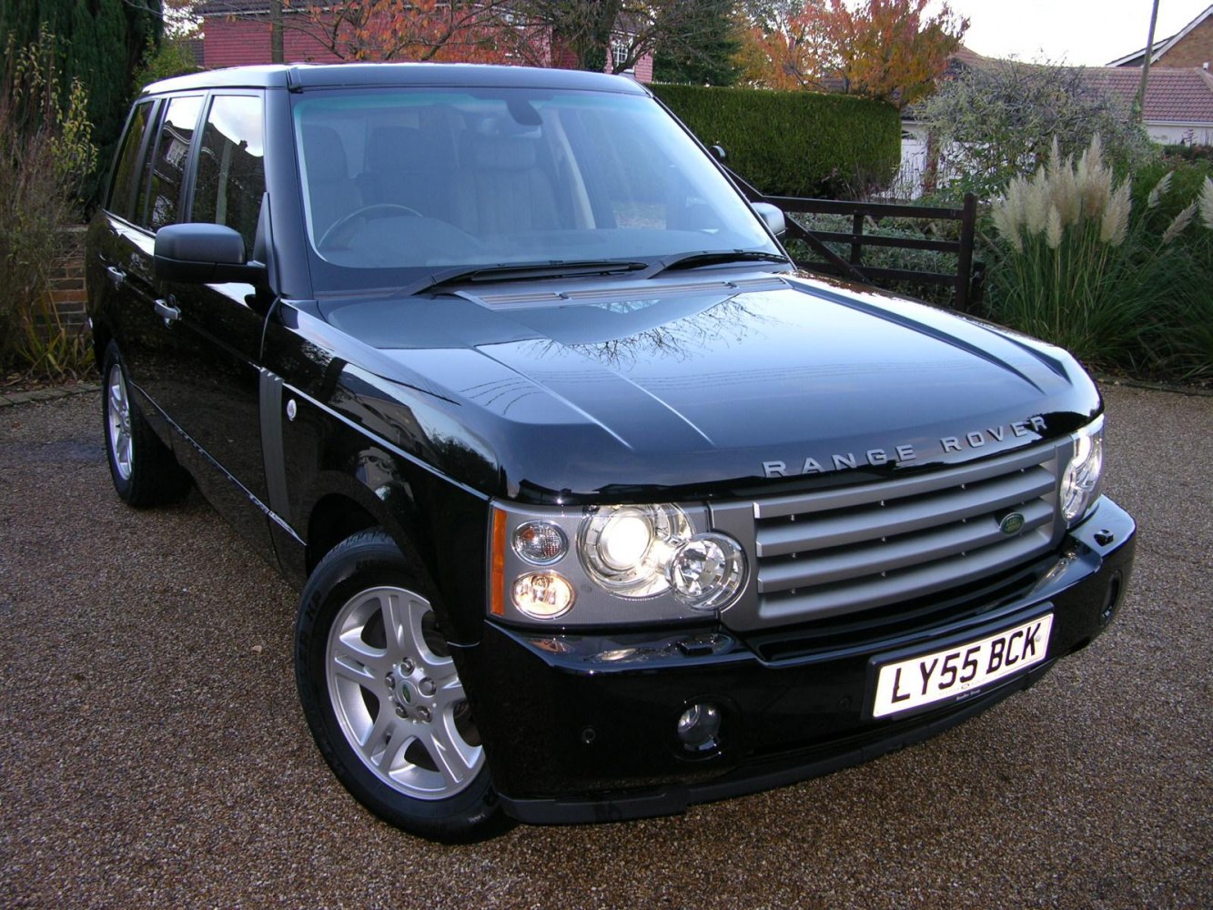 Black Range Rover SUV with headlights on and horizontal grille