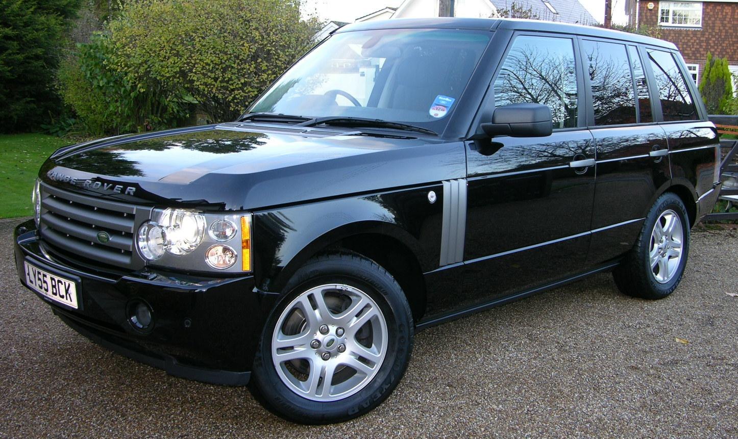 Front side view of black luxury SUV with distinctive grille and headlights