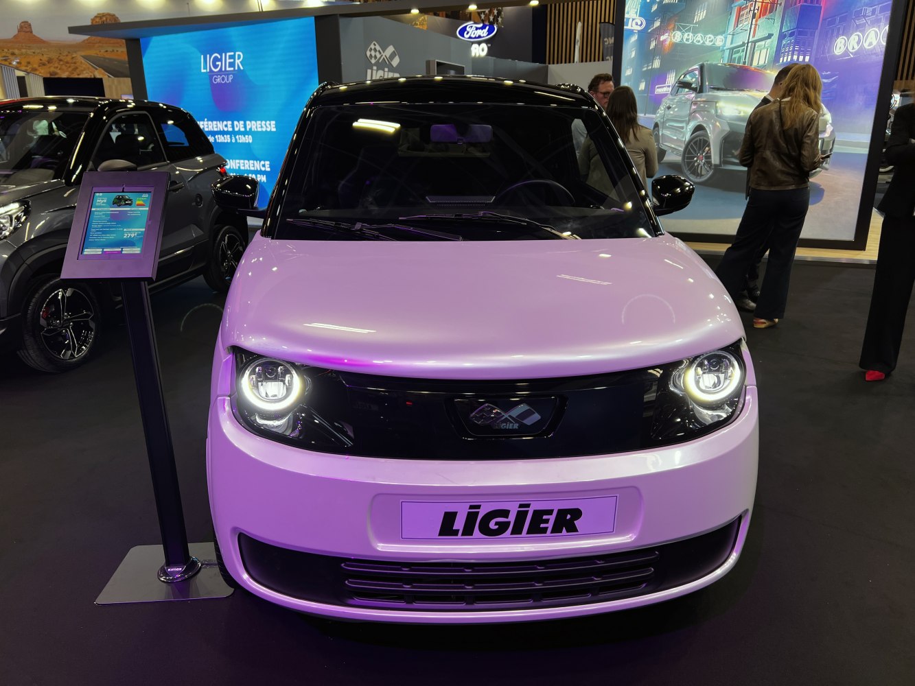 Compact vehicle front with LED ring headlights and minimalist design